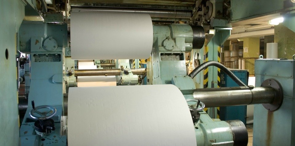Photograph of rolls of paper on a printing press